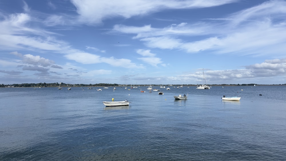 a group of boats floating on top of a large body of water