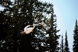 A rider performing a stunt on a downhill track.