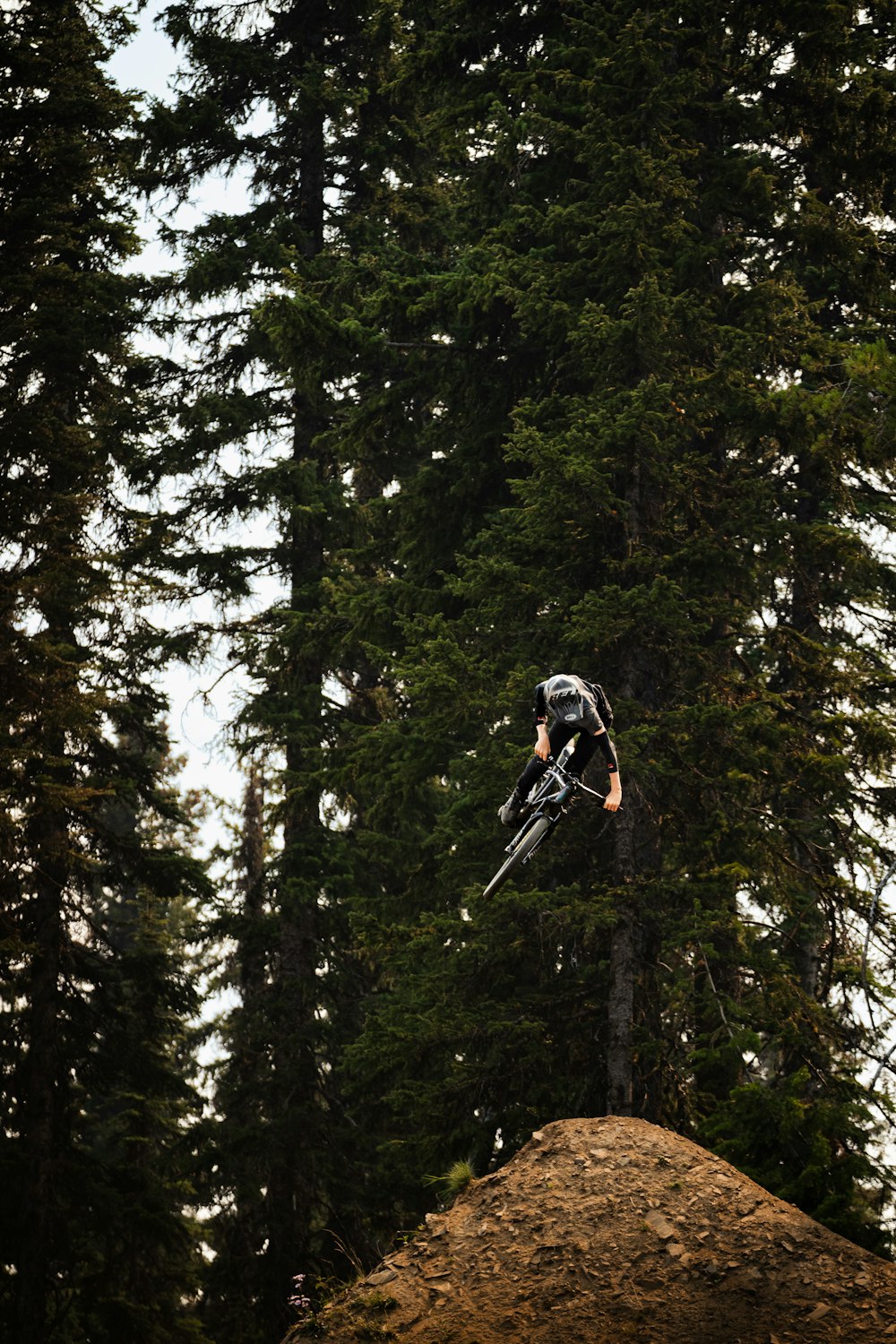 a man flying through the air while riding a bike