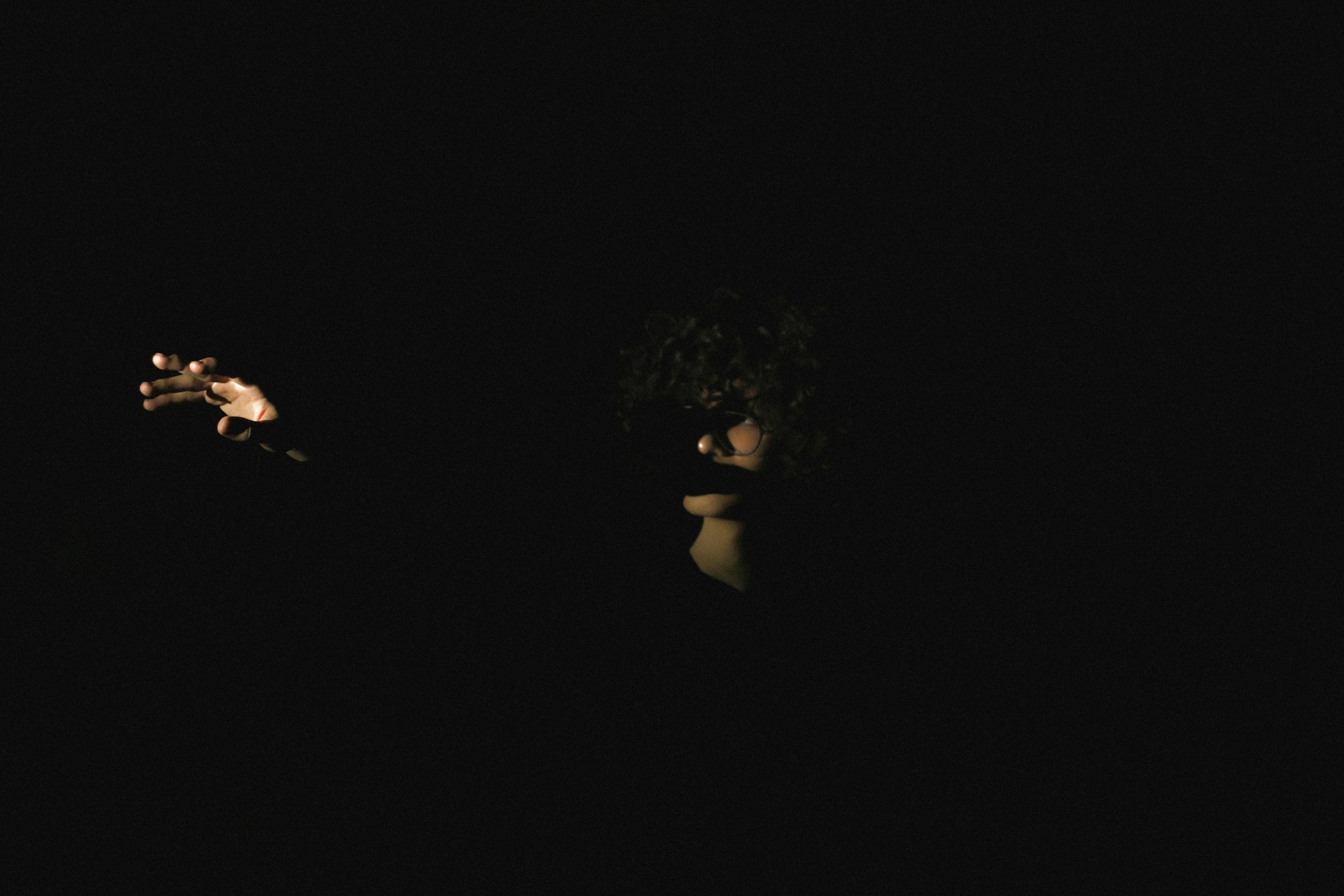 a person in the dark holding a cell phone