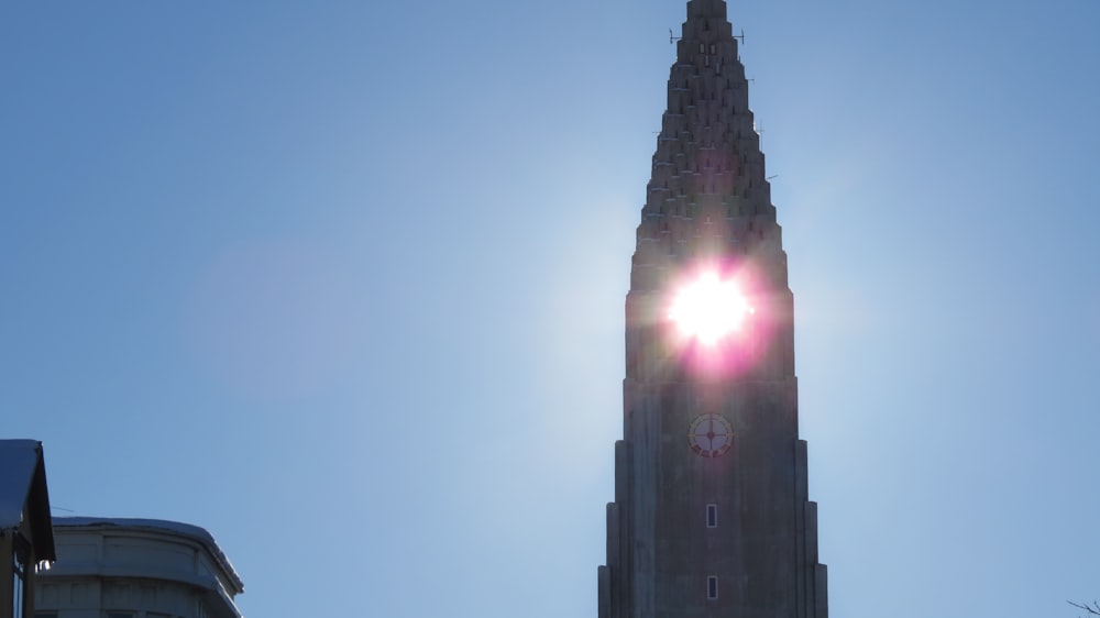 the sun shines brightly in front of a tall building