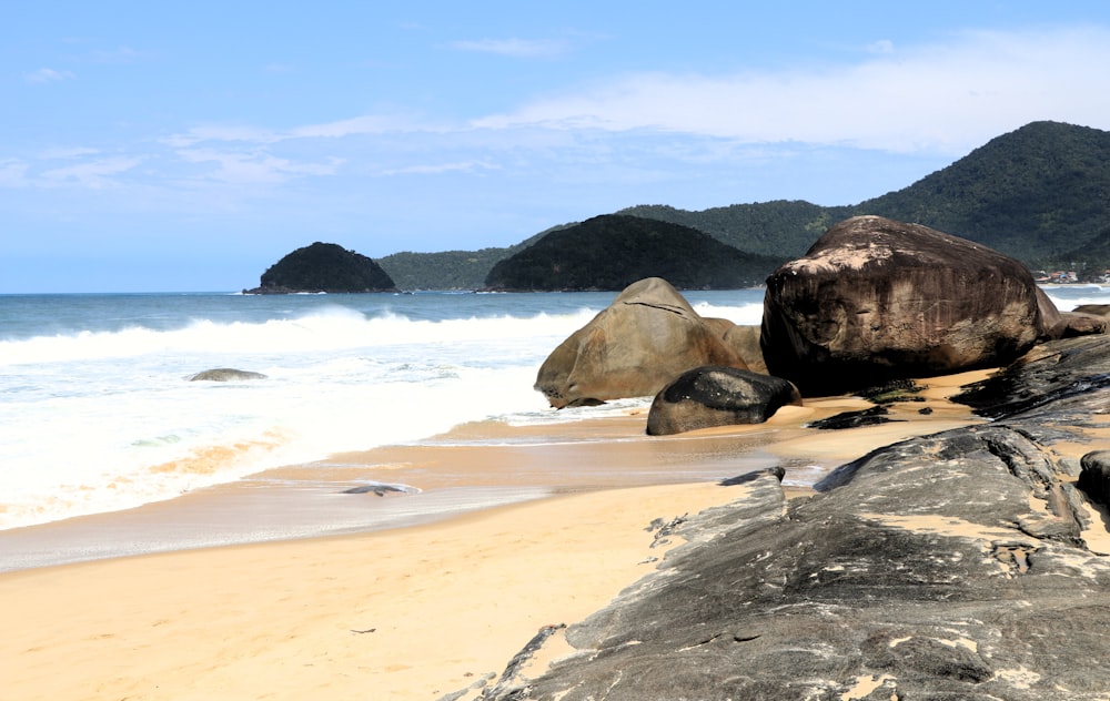 a large rock sitting on top of a sandy beach