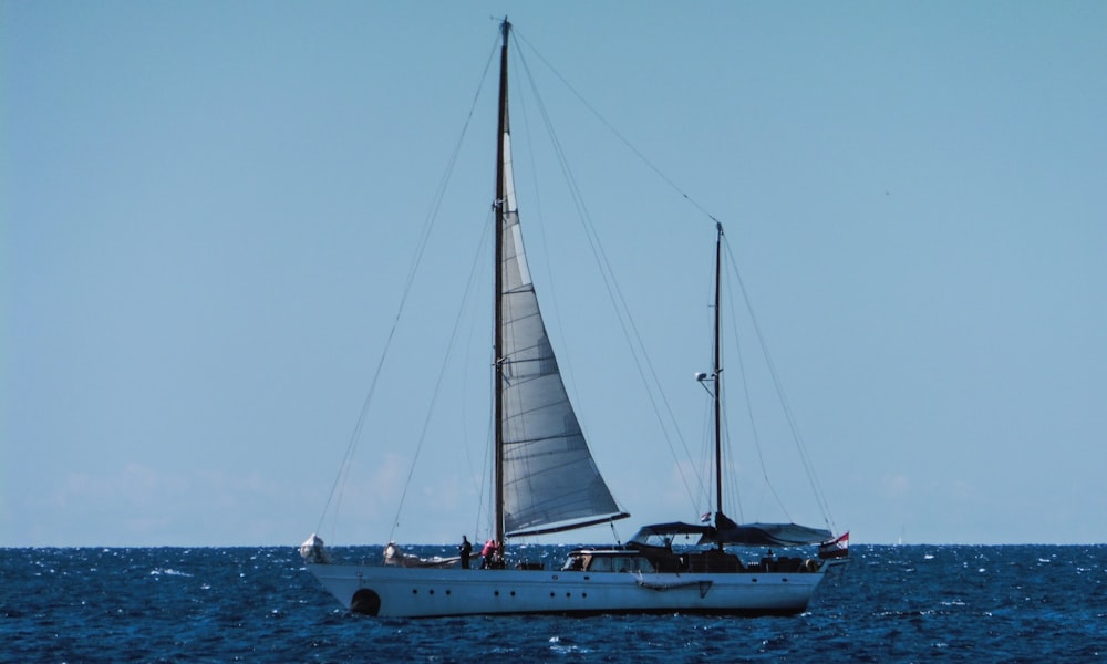 a sailboat in the middle of the ocean