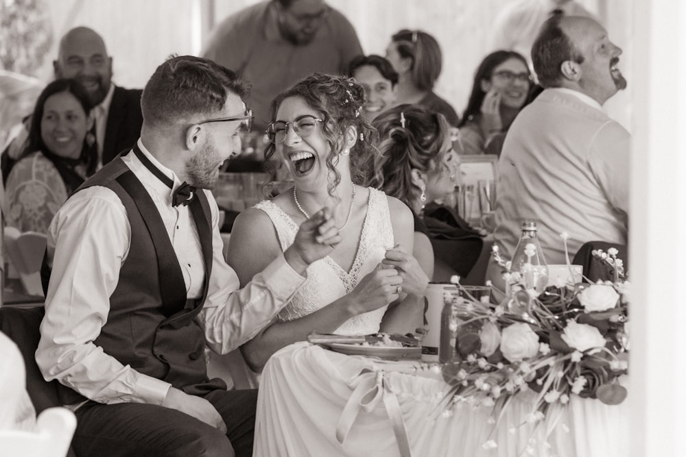 a bride and groom laughing at each other