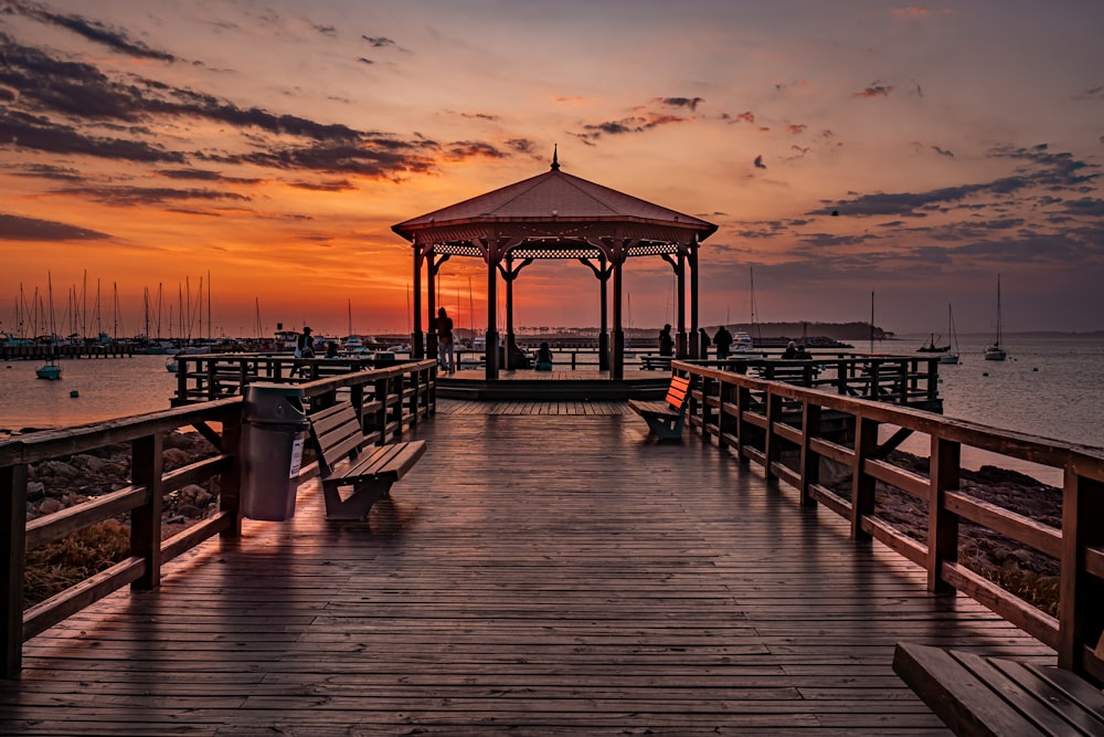 a gazebo sitting on top of a wooden pier