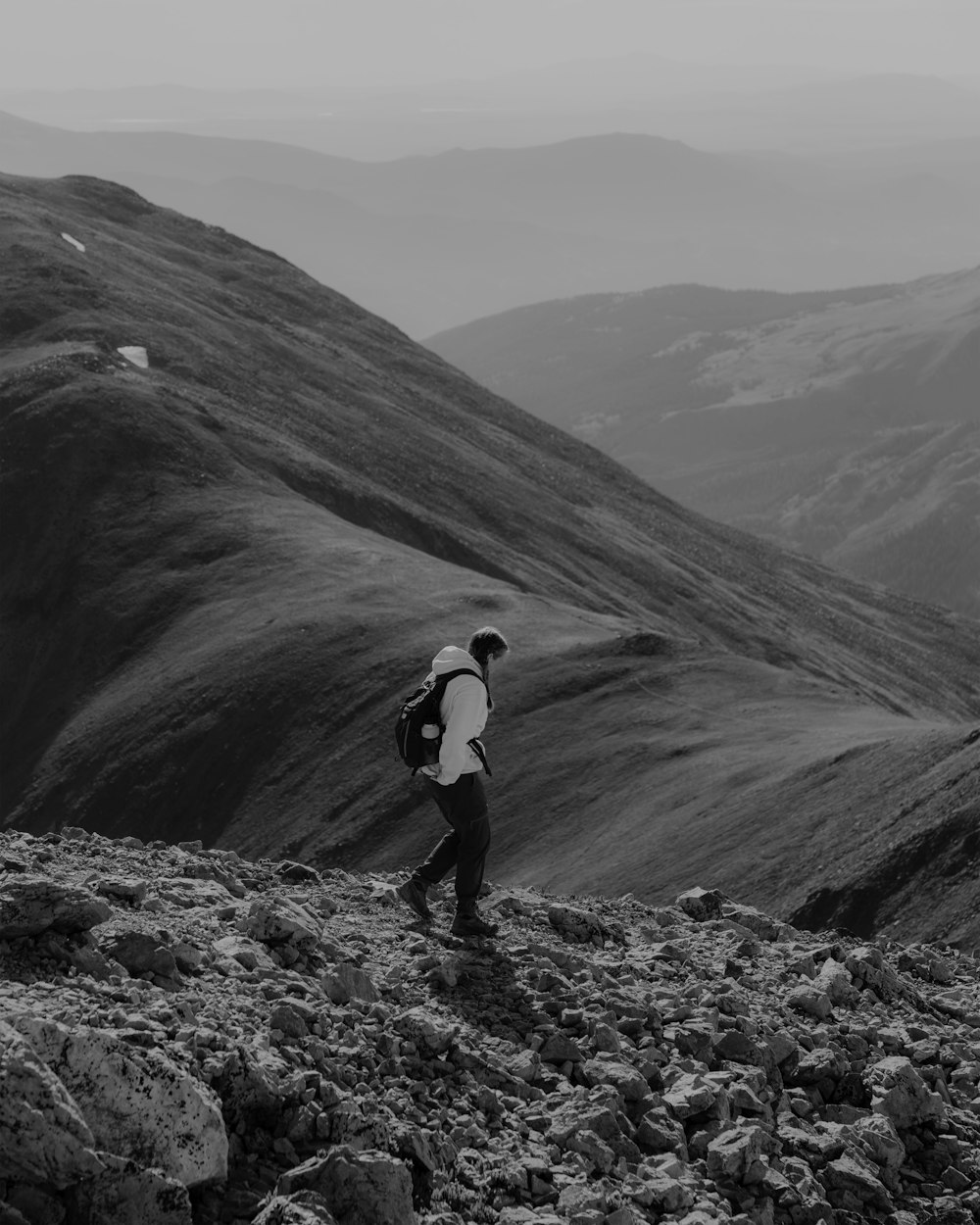 a man with a backpack walking up a hill