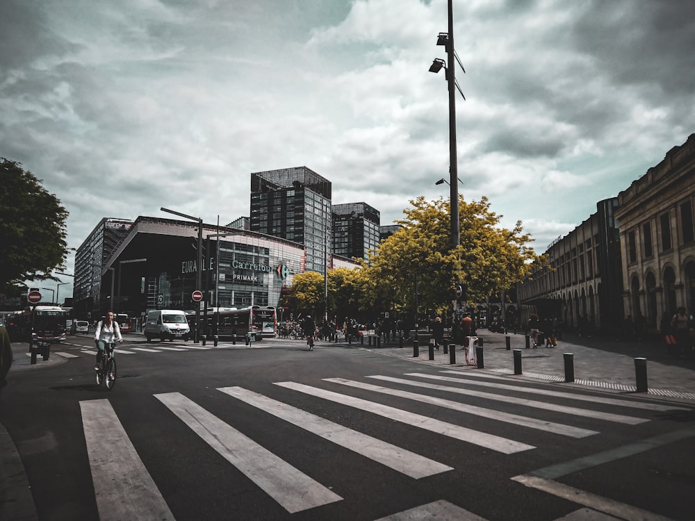 a person riding a bike on a city street