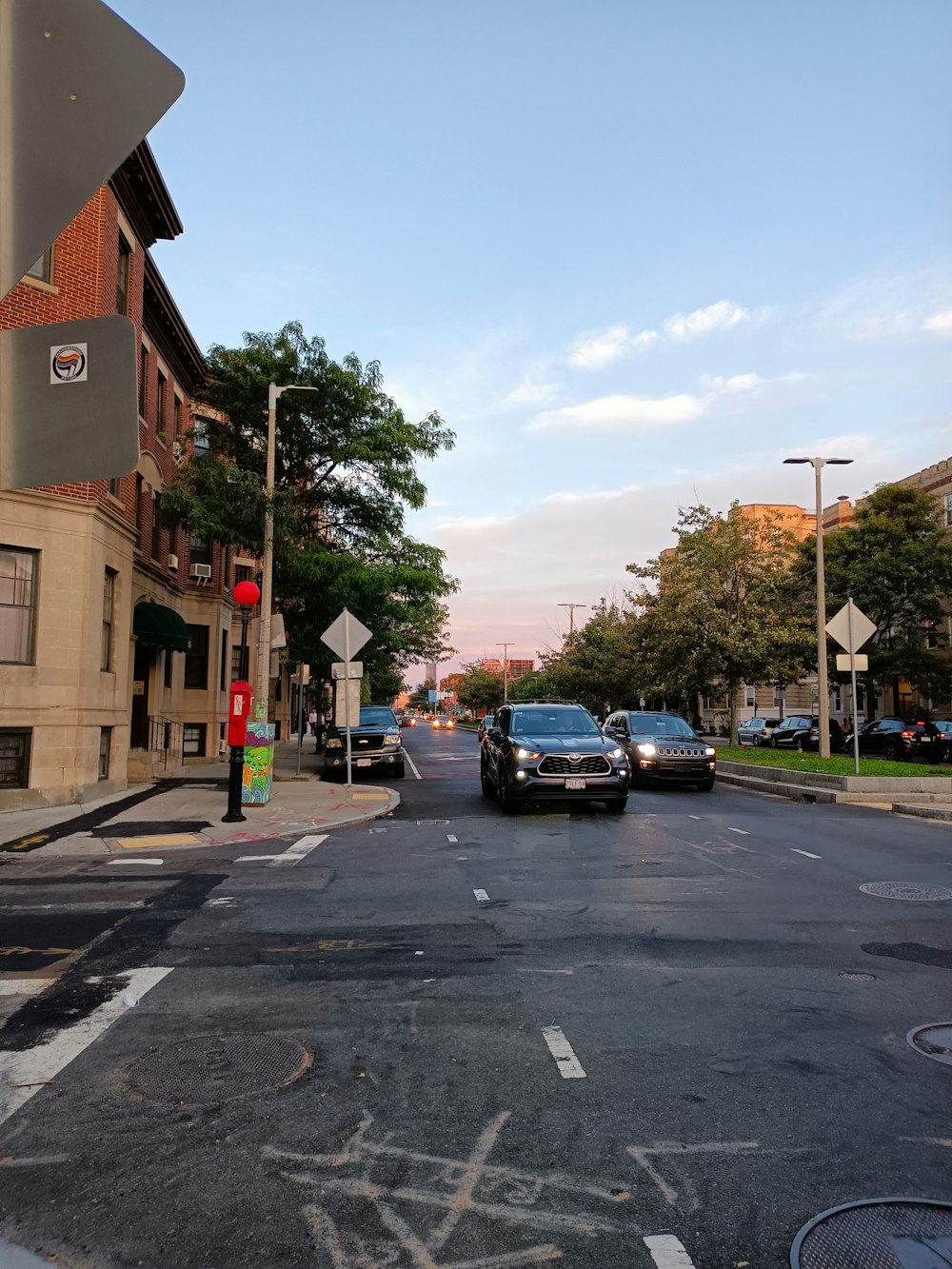 a city street with cars parked on the side of the road