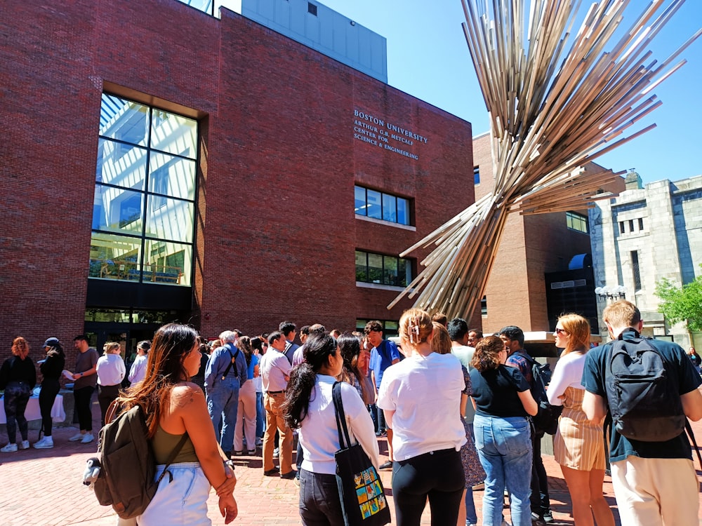 a group of people standing in front of a building