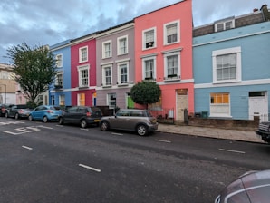 a row of multi - colored houses on a street