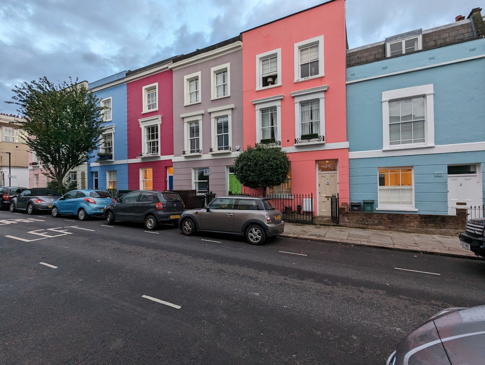 a row of multi - colored houses on a street
