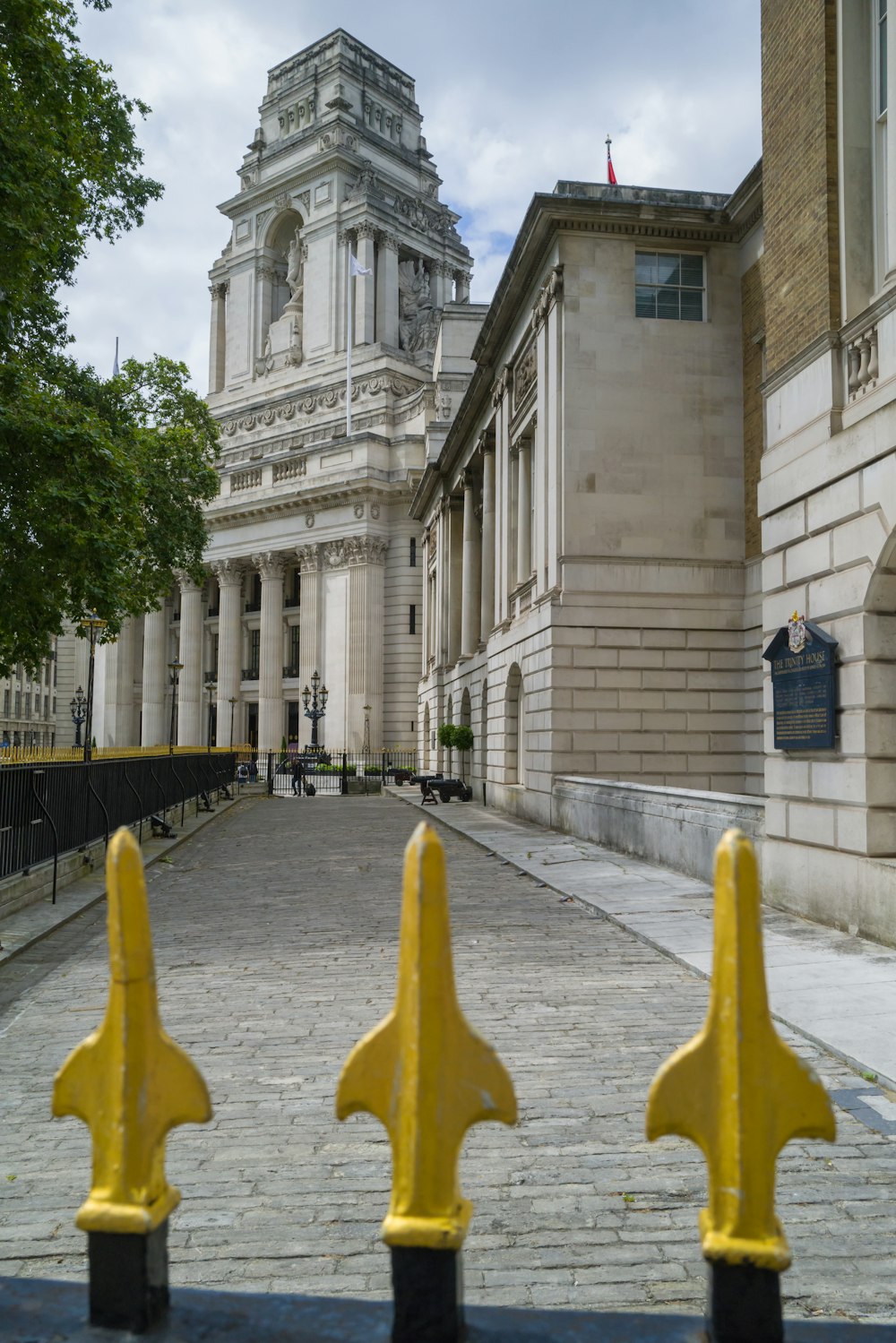 a yellow fence in front of a large building