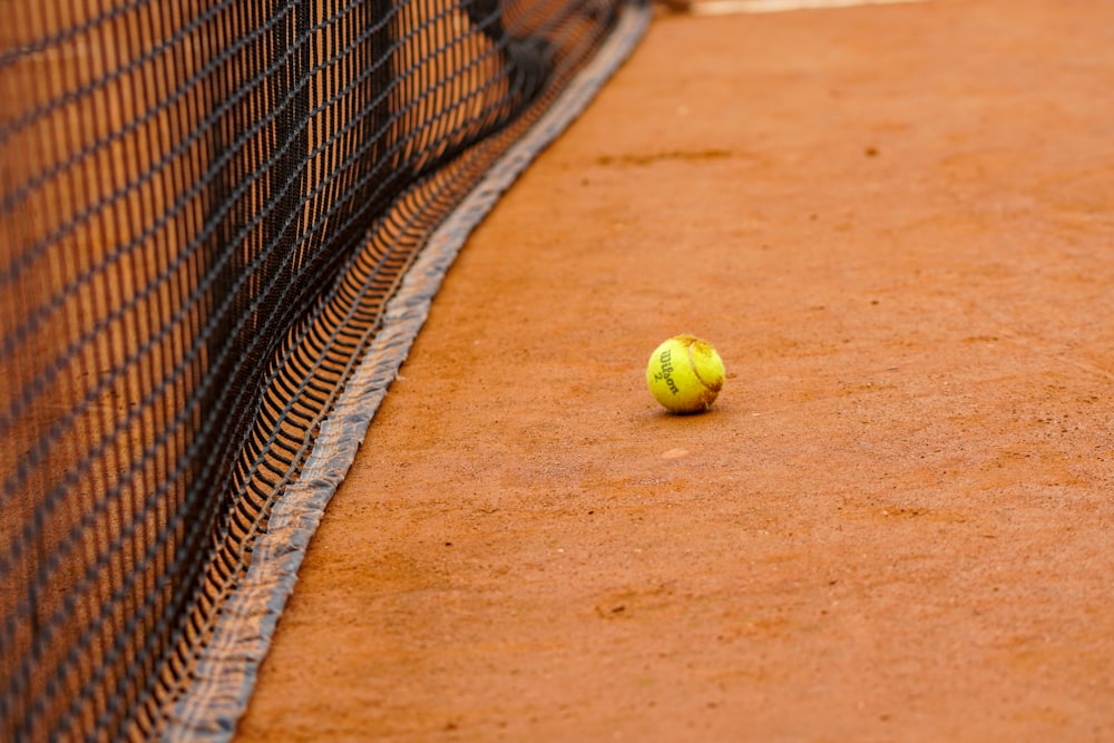 a tennis ball sitting on a tennis court