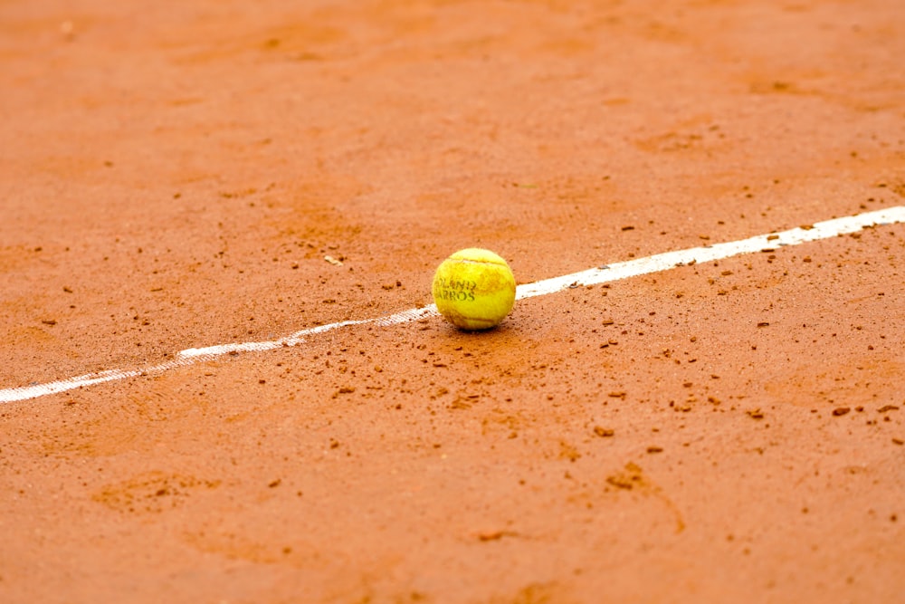 a tennis ball sitting on a tennis court