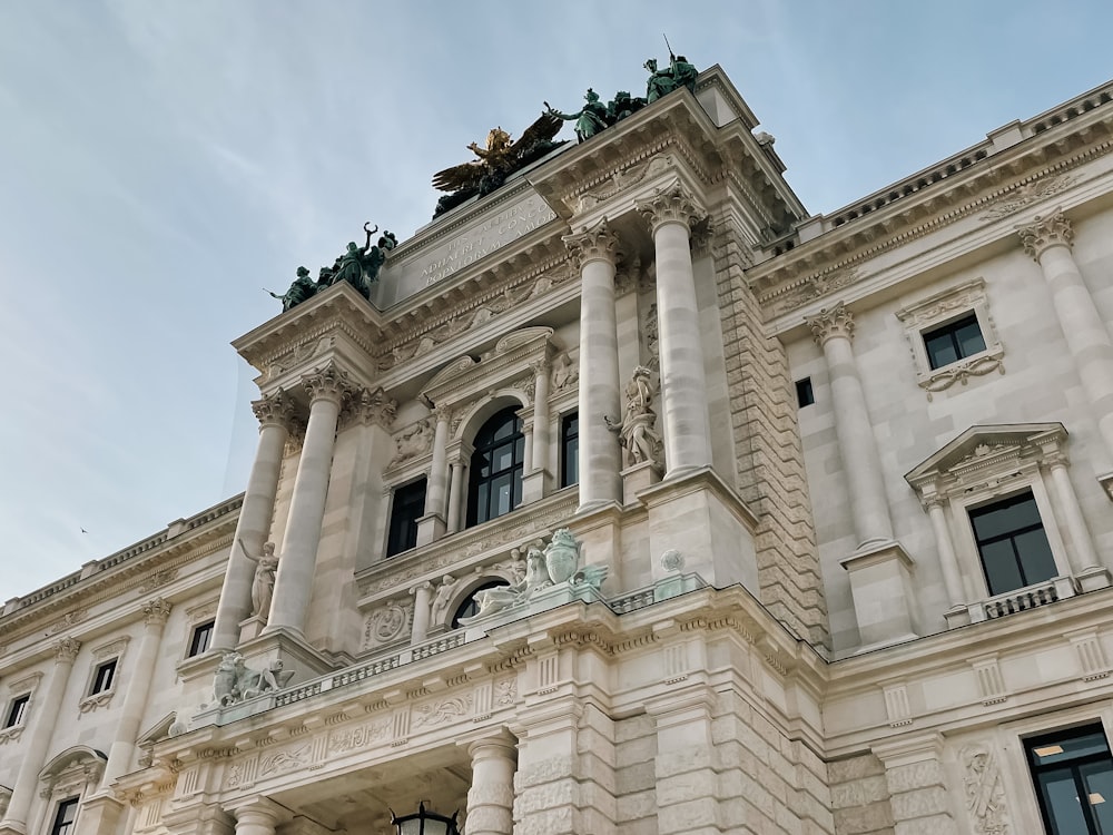 a large white building with statues on top of it