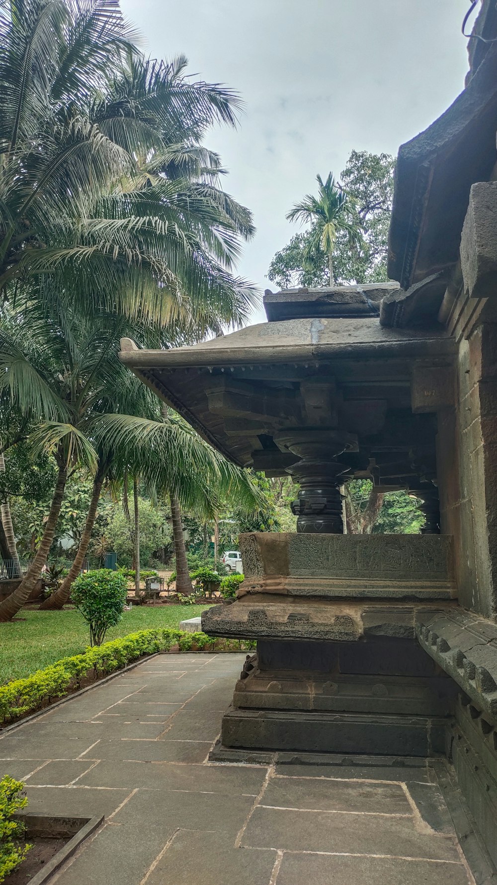 a stone building with a fountain in the middle of it