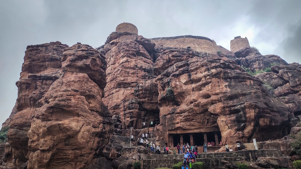 a group of people standing in front of a mountain