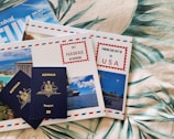 a couple of passports sitting on top of a bed