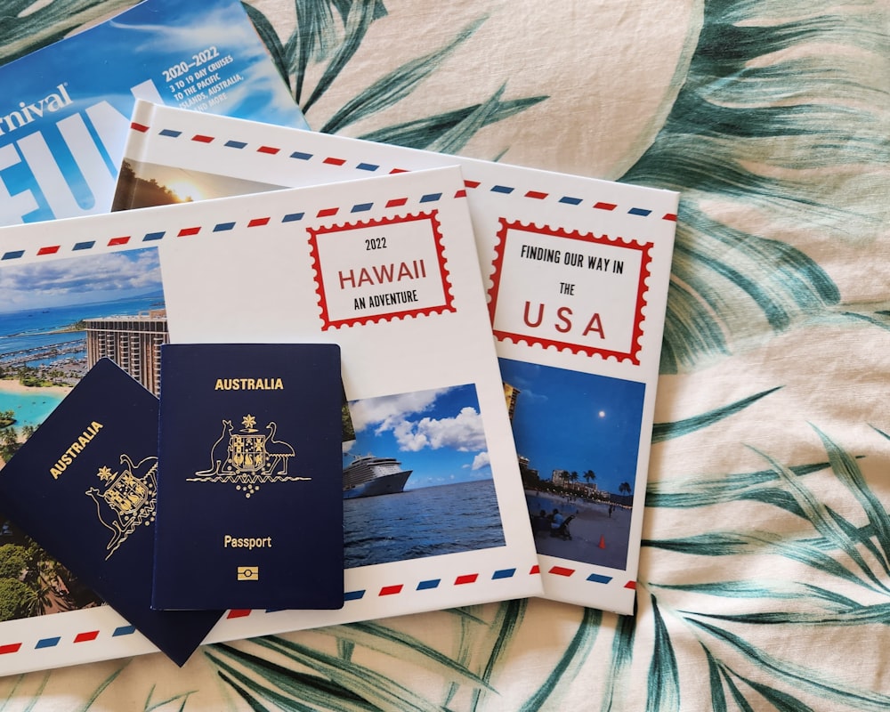 a couple of passports sitting on top of a bed