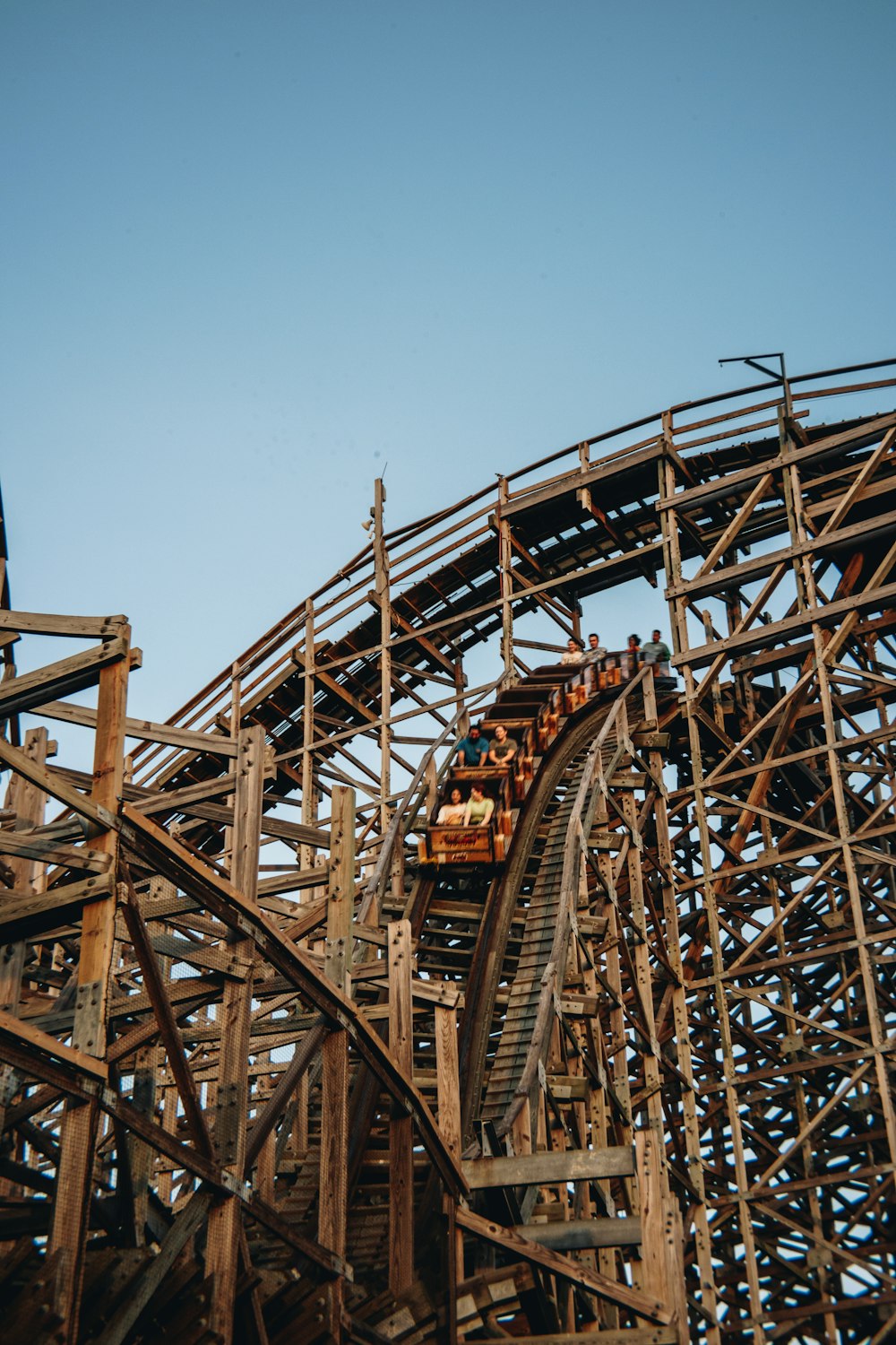 a roller coaster going down a hill on a clear day