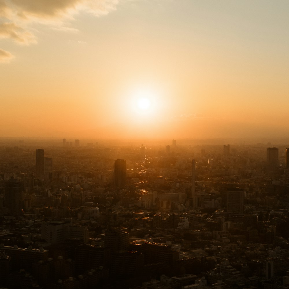 the sun is setting over a large city