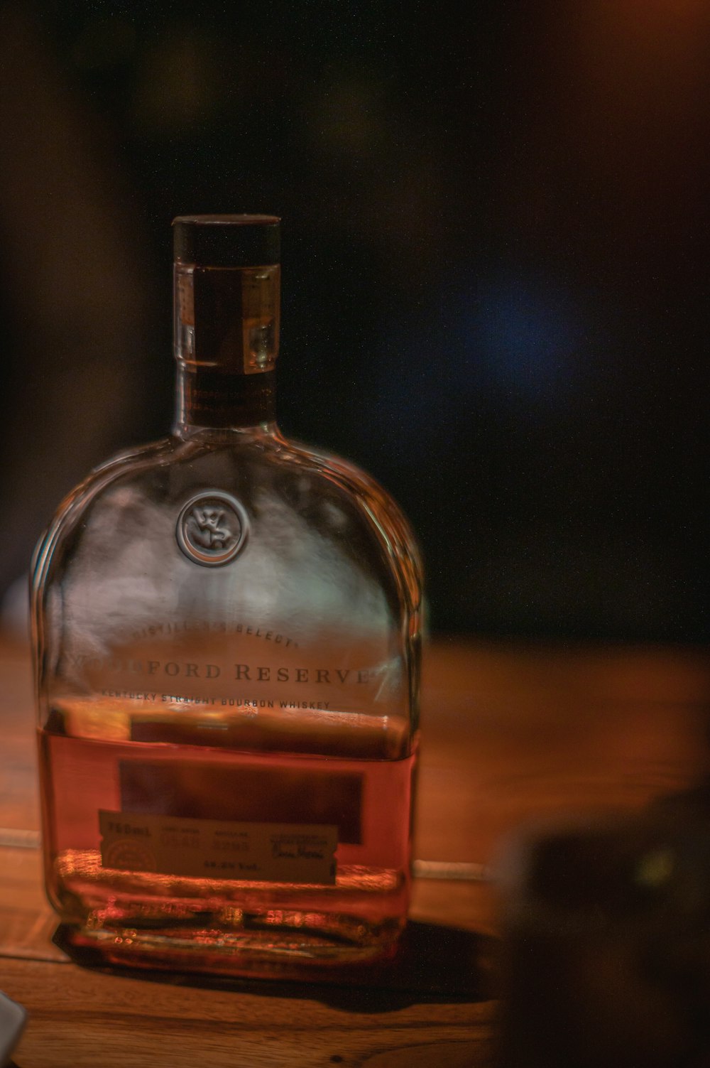 una bottiglia di whisky seduta sopra un tavolo di legno