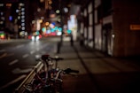 A set of colorful bike lights glowing against a twilight city backdrop.