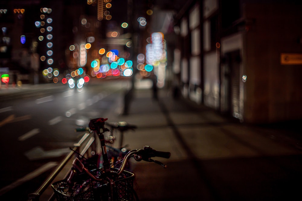 a bike parked on the side of a street at night