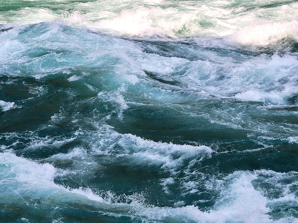 a man riding a surfboard on top of a wave in the ocean