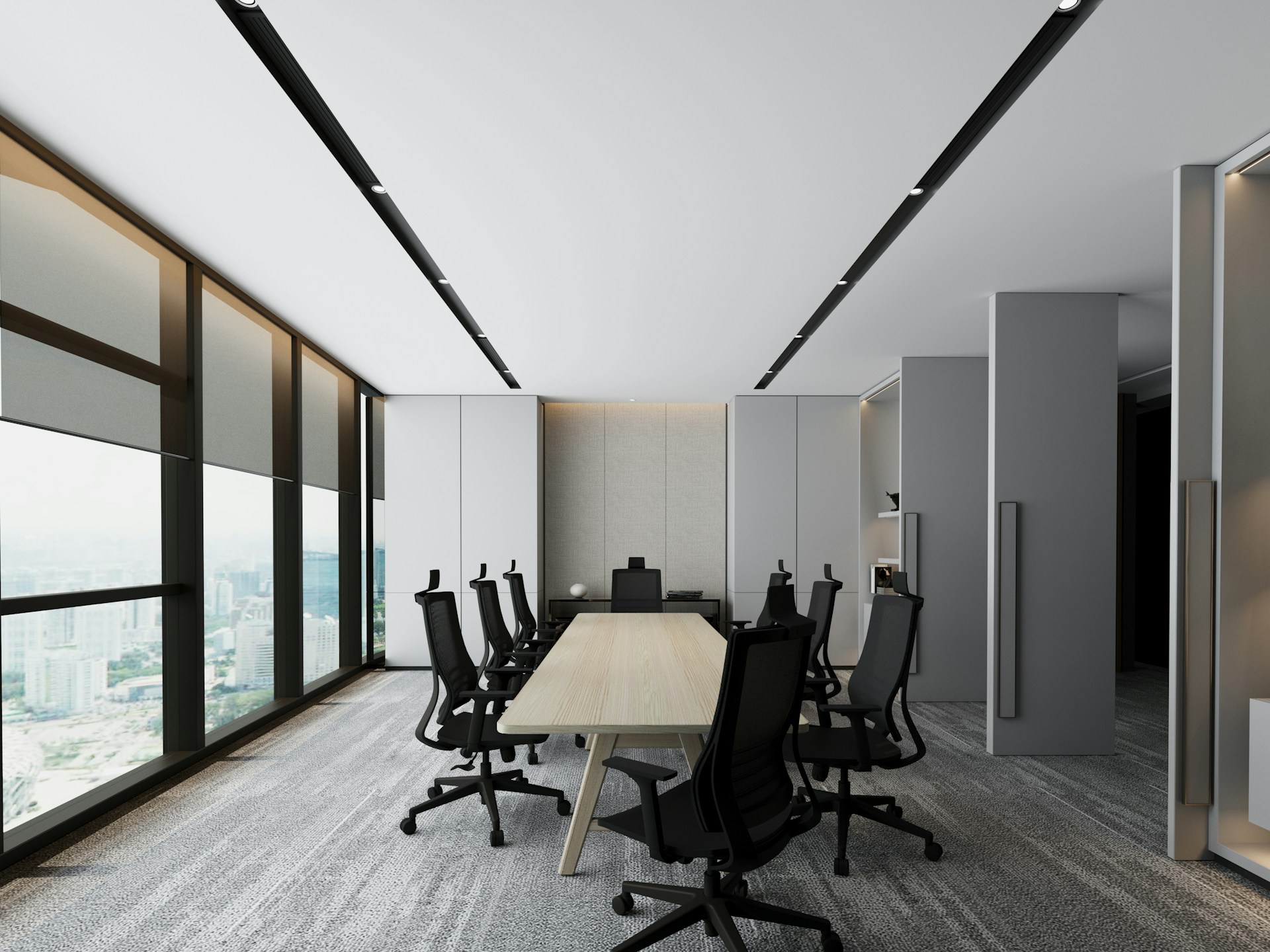 a conference room with a long table and black chairs