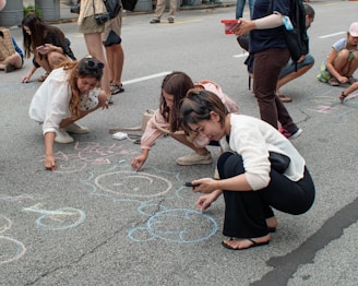 a group of people drawing on the ground