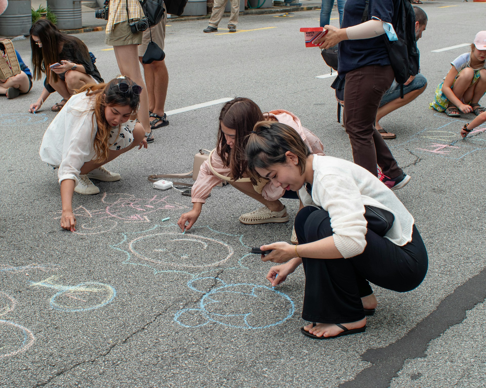 a group of people drawing on the ground