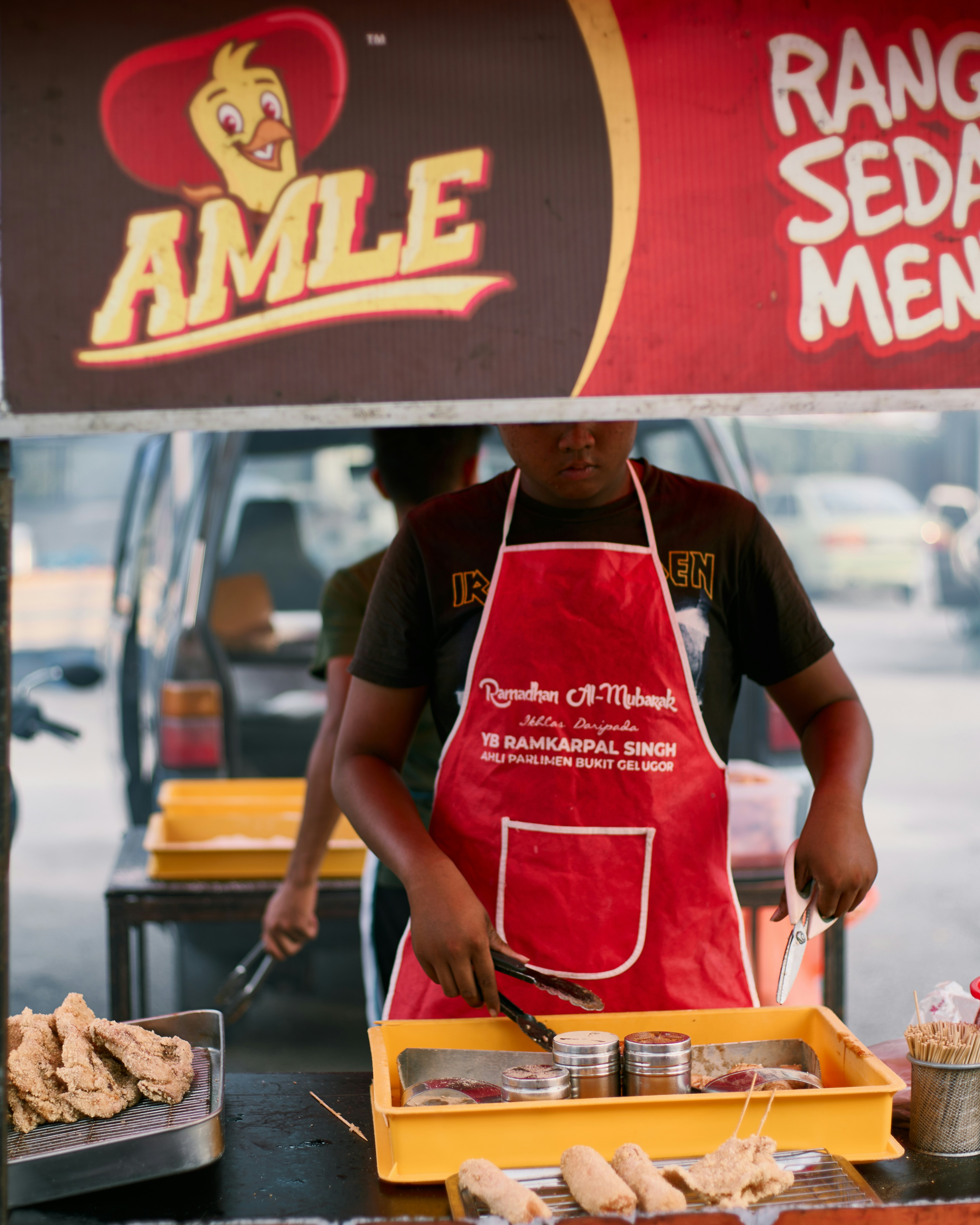 a man in an apron preparing food on a table