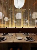 A chic dining area featuring a stylish table and ambient lighting.