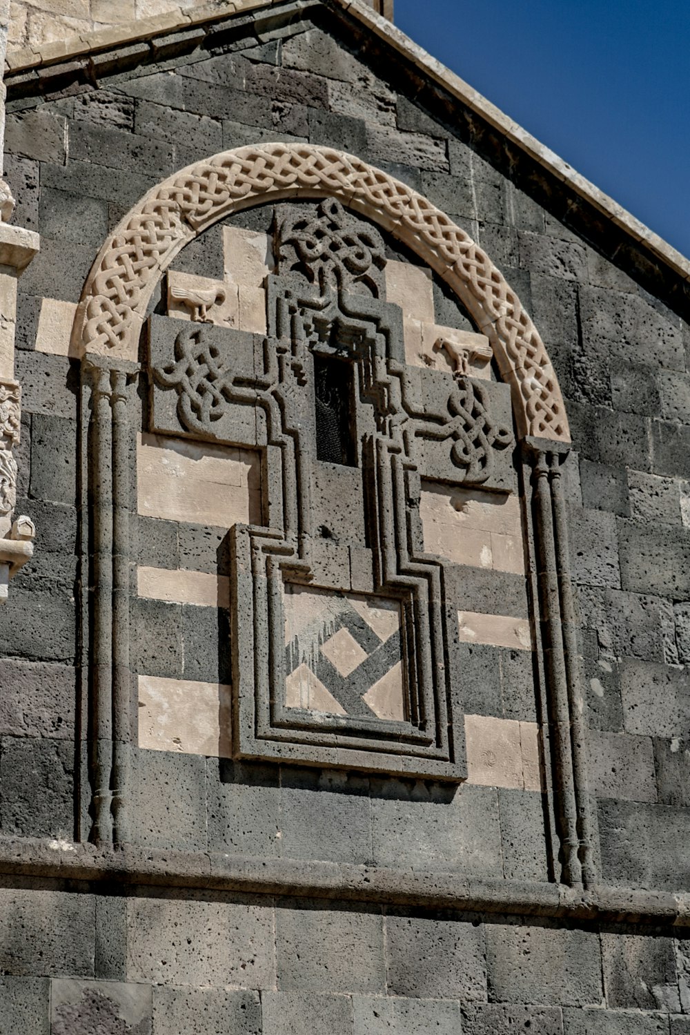 a large stone building with a clock on it's side