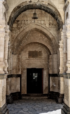 An elegant stone archway with intricate geometric carvings, hinting at timeless wisdom.