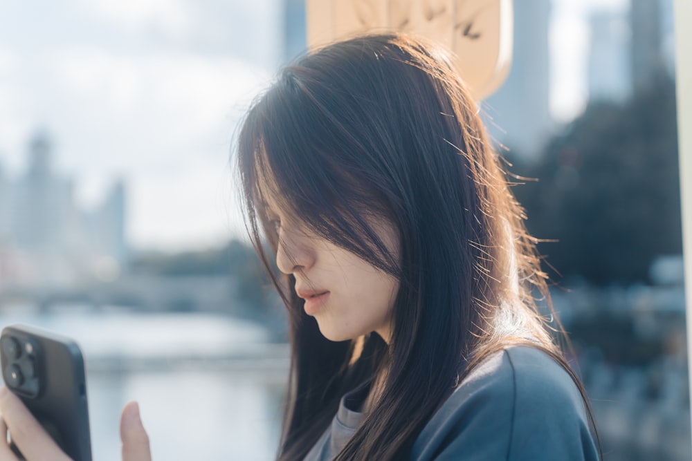 a woman holding a cell phone in her hand