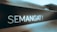 A close-up of a sign or board with the word 'SEMANGAT!' written in bold, bright letters, which appears to be illuminated or glowing against a dark background. The setting conveys a sense of motivation or encouragement.