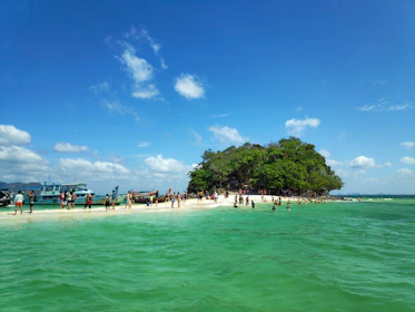 A vibrant photo of tourists enjoying a guided beach tour on Havelock Island.