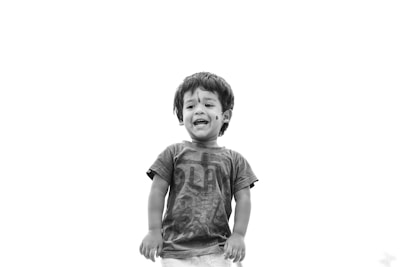 Happy kids dressed in trendy outfits posing against a plain background.
