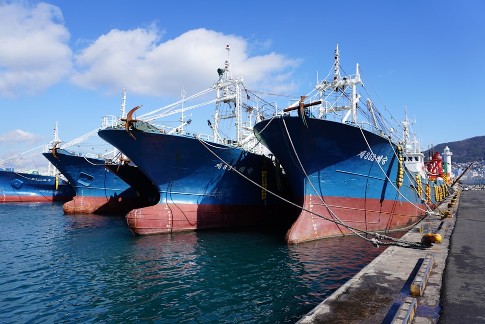 two large ships are docked in the water