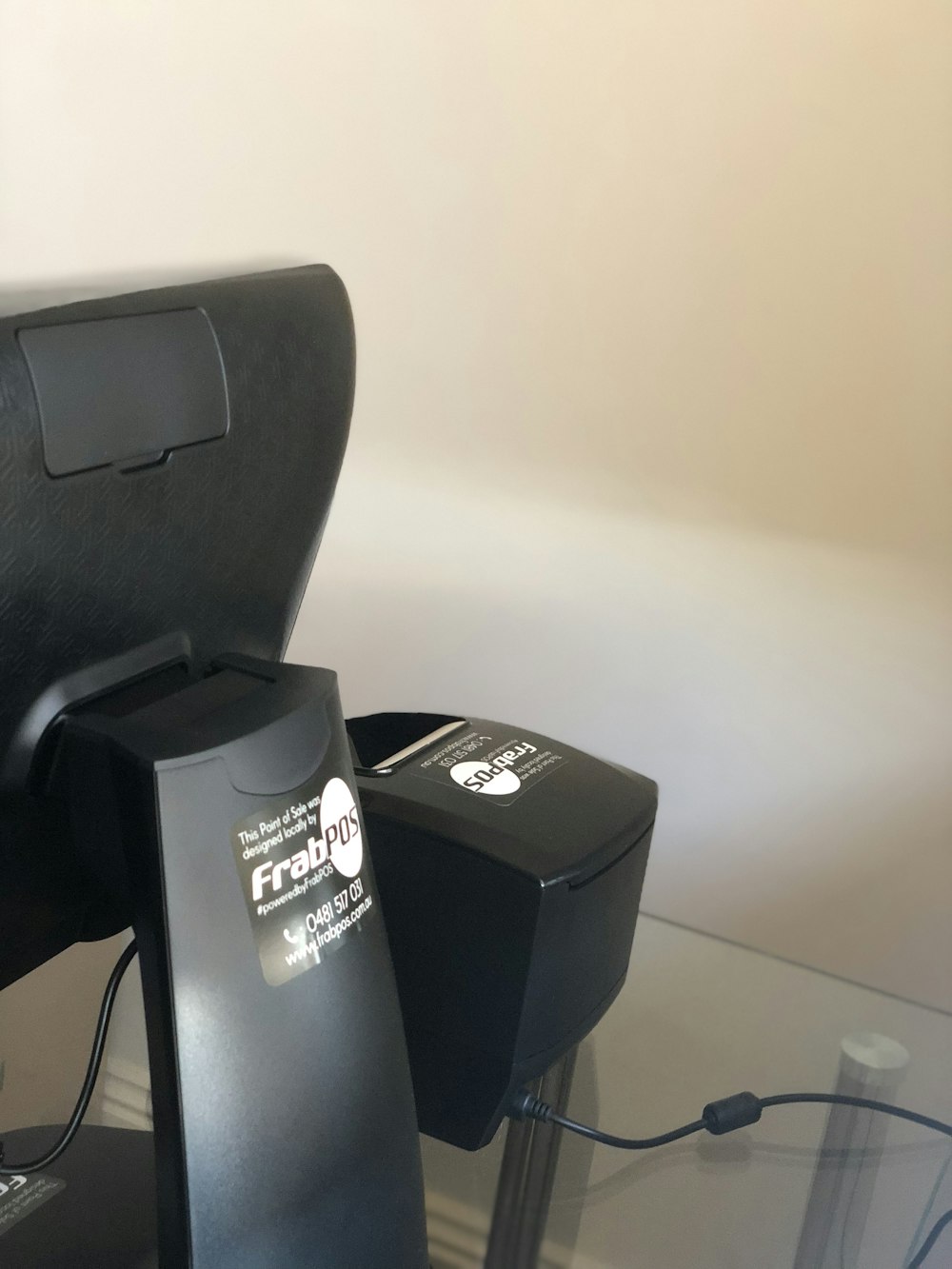 a glass table topped with a black computer chair