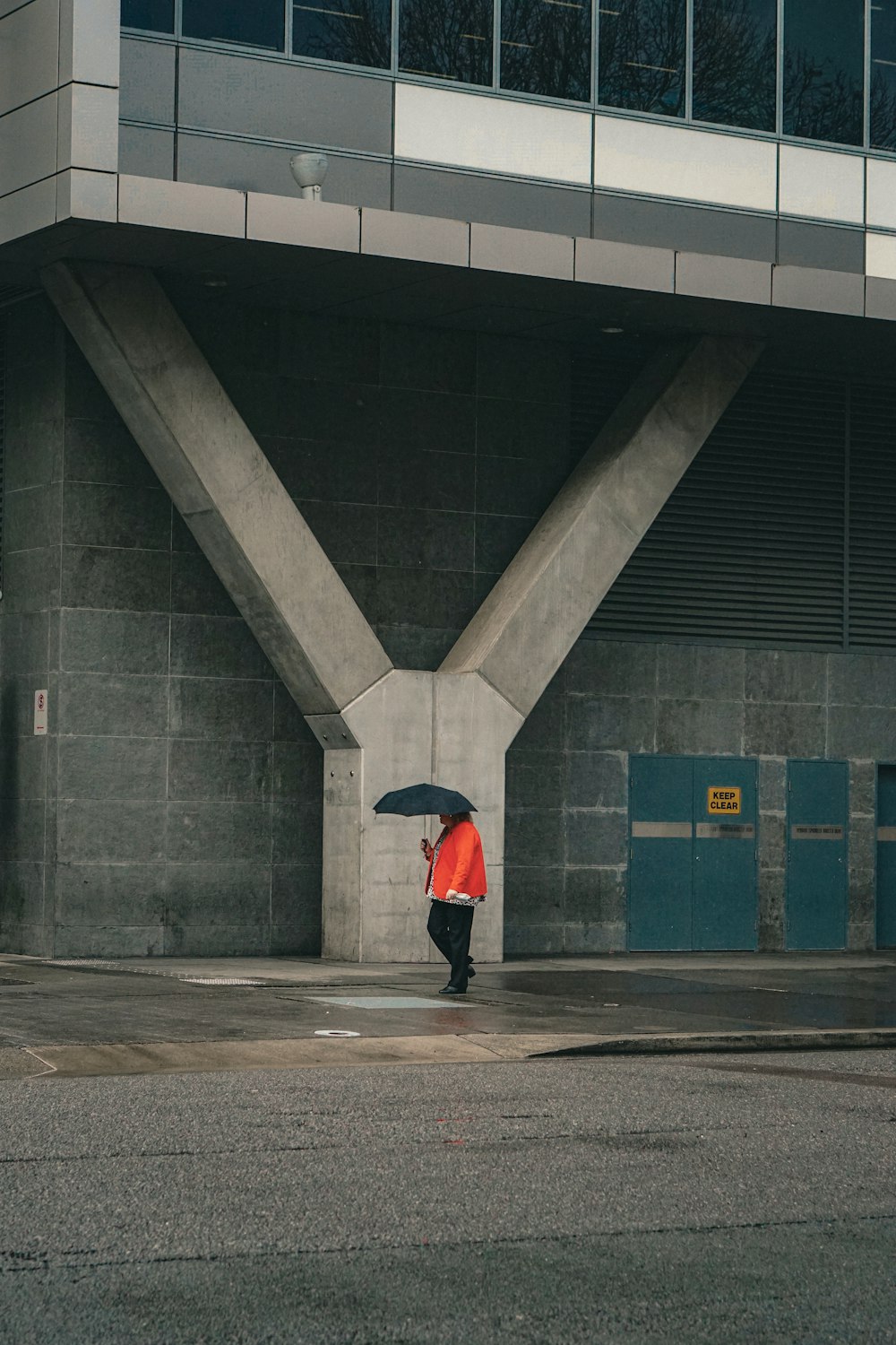 a person walking down a street holding an umbrella