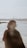 a woman standing on top of a beach next to the ocean