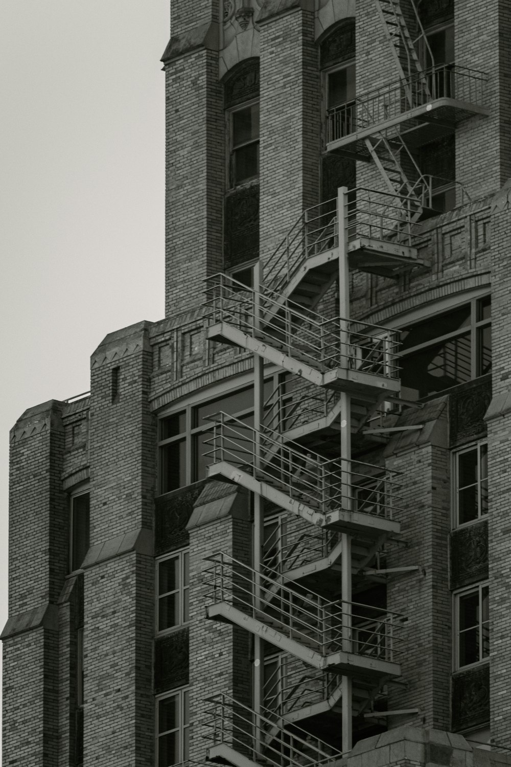 a black and white photo of a building with a fire escape