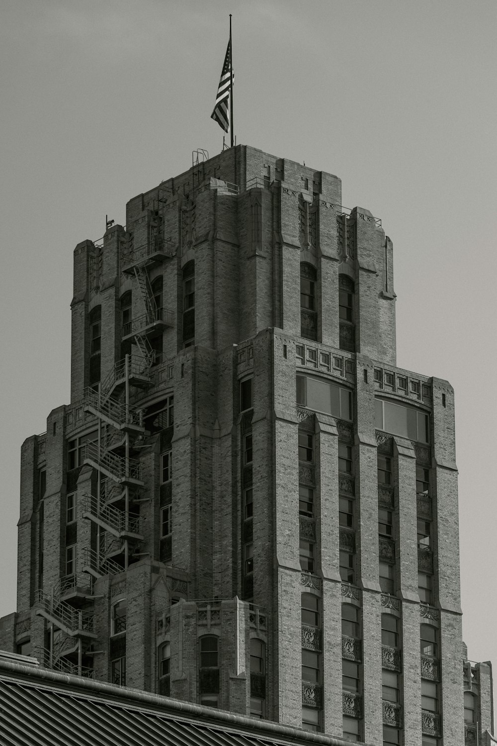 a tall building with a flag on top of it