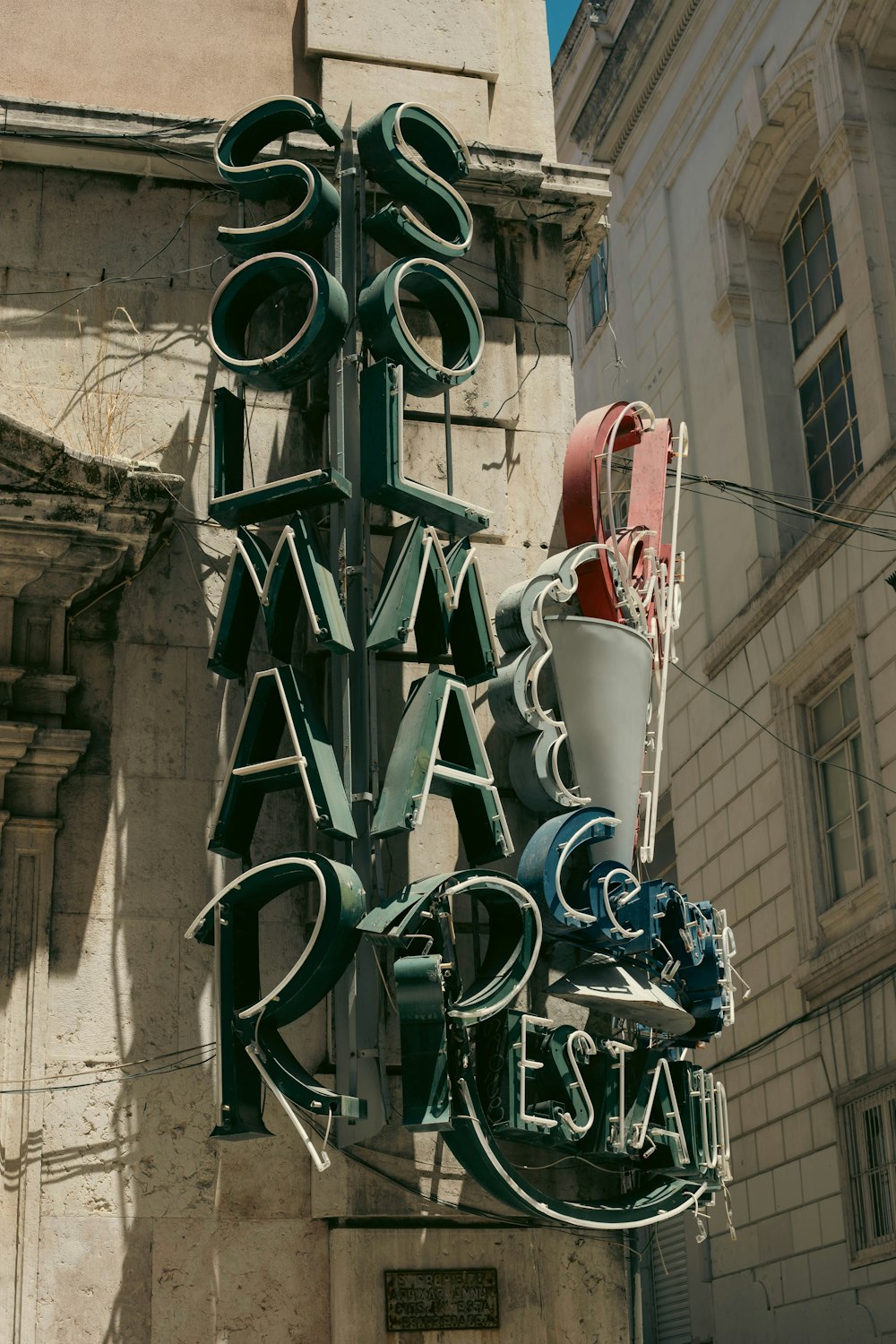 a sign for a restaurant on the side of a building