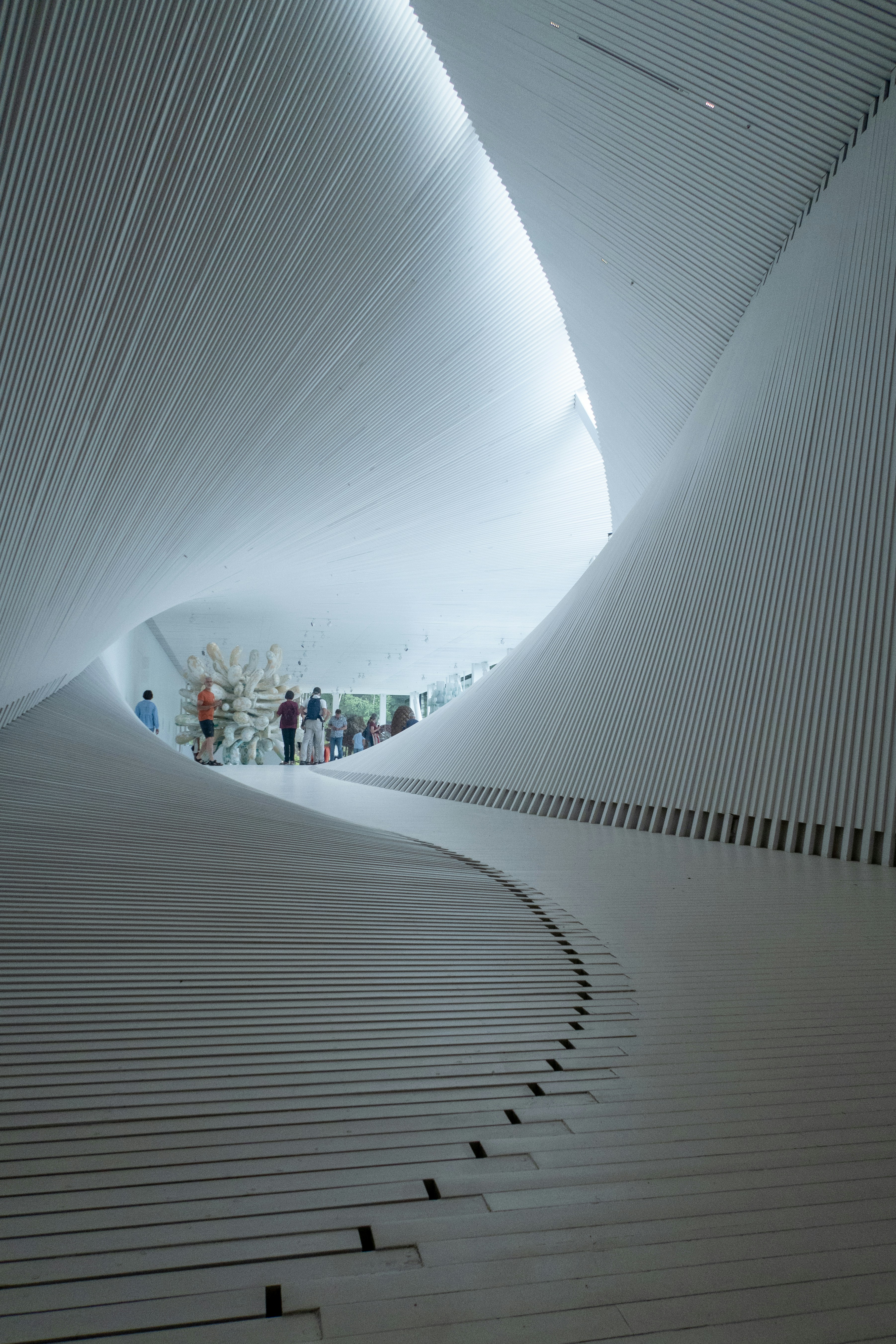 a group of people standing inside of a white building
