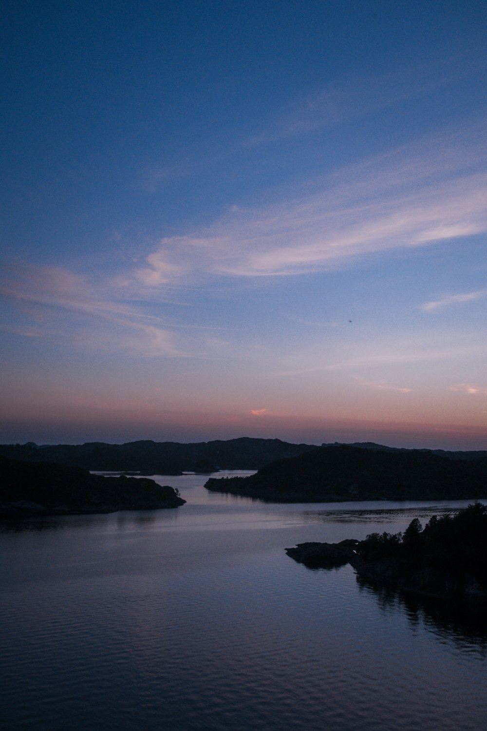 a body of water with a sky in the background