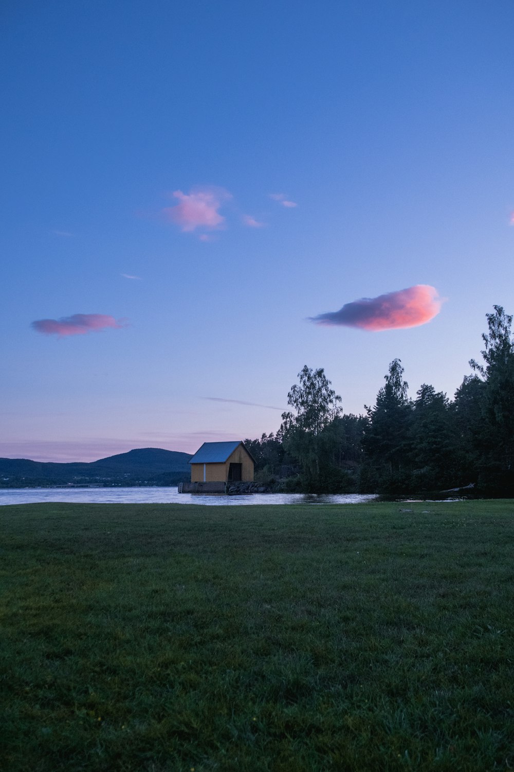 a house sitting on top of a lush green field